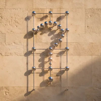 Chrome Question Mark on Stone Wall