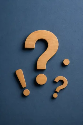 Large Wooden Question Mark on Blue Background