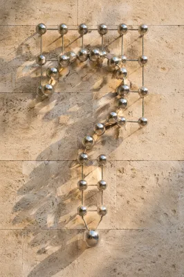 Chrome Question Mark on Stone Wall