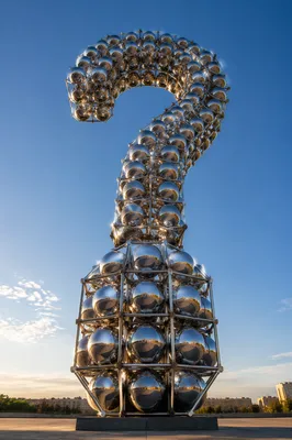 Monumental Chrome Question Mark Under Open Sky