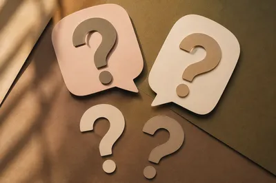 Large Paper Question Marks on Neutral Background