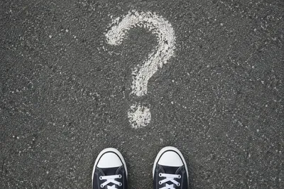 White Question Mark on Gray Asphalt
