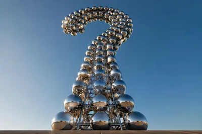 Monumental Chrome Question Mark Under Open Sky