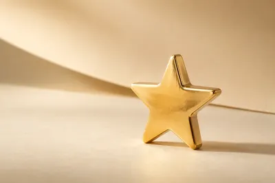 Shiny Gold Star Icon on Cream