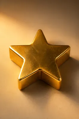 Shiny Gold Star Icon on Beige Surface