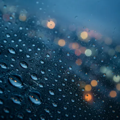 Rain Droplets on Glass at Dusk