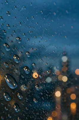 Rain Droplets on Glass at Dusk