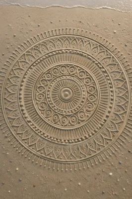 Symmetrical Sand Mandala on Beach Shore