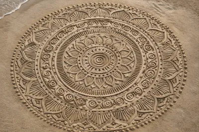 Symmetrical Sand Mandala on Beach Surface