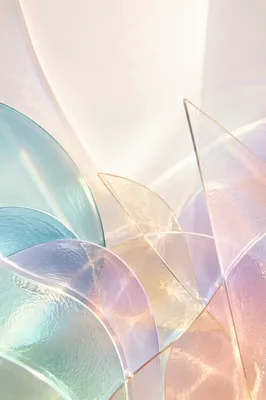 Iridescent Glass Arcs on Pale Background