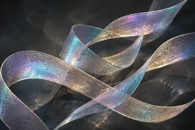Iridescent Glass Ribbons on Charcoal Background