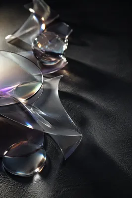 Iridescent Glass Shapes on Dark Surface