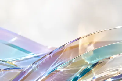 Iridescent Glass Arcs on Pale Background