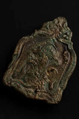 Weathered Bronze Plaque Fragment on Black