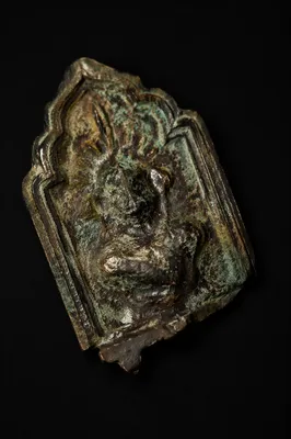 Weathered Bronze Plaque Fragment on Black