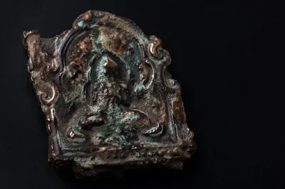 Weathered Bronze Plaque Fragment on Black