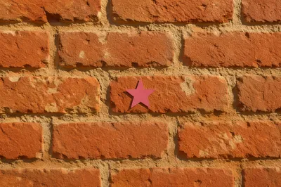 Aged Red Brick Wall With Magenta Star