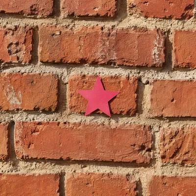 Aged Red Brick Wall with Magenta Star
