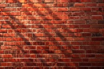 Sunlit Red Brick Wall Texture Background