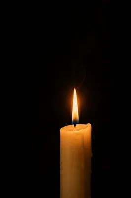 Single Ivory Candle on Dark Background