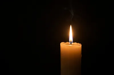 Single Ivory Candle on Dark Background