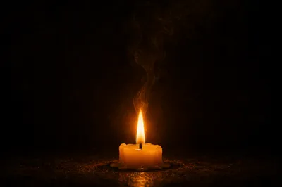 Single Candle Flame in Quiet Darkness