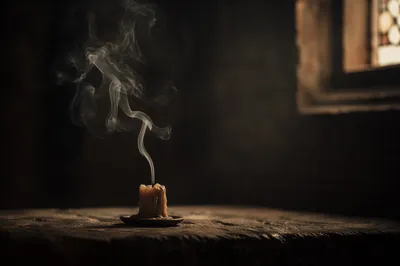 Extinguished Candle Smoke in Dark Sanctuary