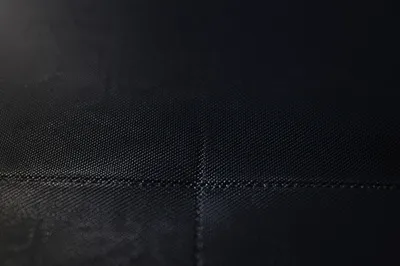 Subtle Cross on Dark Textured Fabric