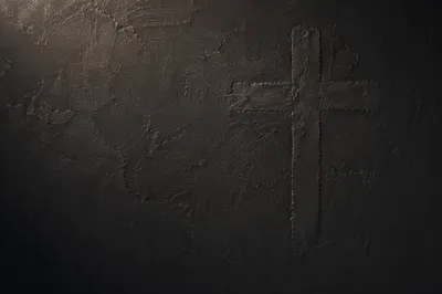 Subtle Cross on Dark Textured Wall