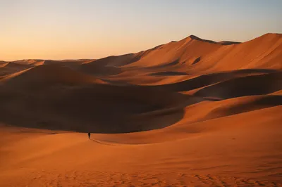 Golden Hour Desert Dunes Under Vast Sky
