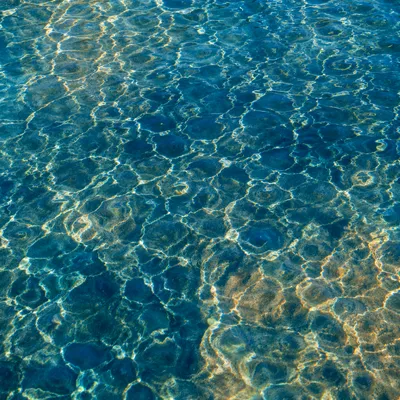 Golden Reflections on Flowing Turquoise Water