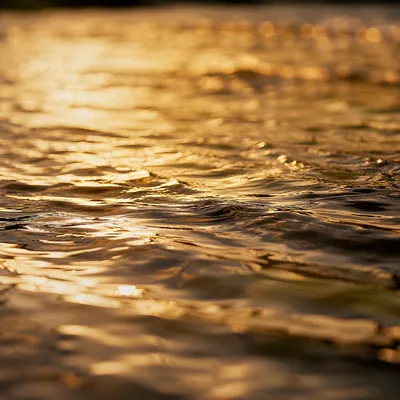 Golden River Ripples at Sunset