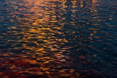 Golden Reflections on Flowing Dusk Water