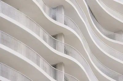 Minimalist White Facade Geometric Wave Background