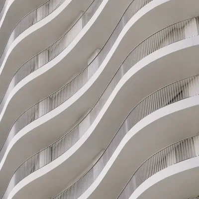 Minimalist White Facade With Geometric Waves