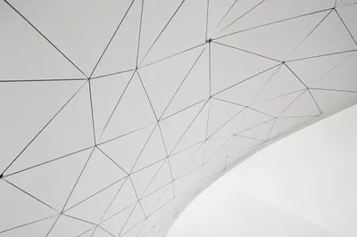 Minimalist Geometric Lines on Curved White Architecture
