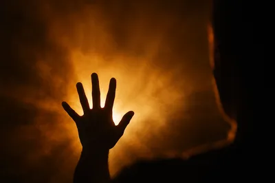 Golden Light Rays With Uplifted Hand