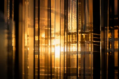 Golden Light Rays Through Abstract Glass