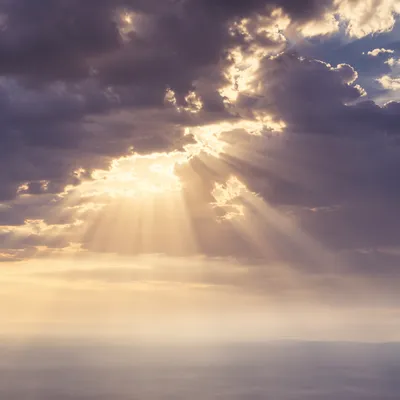 Golden Heavenly Light Rays Through Clouds