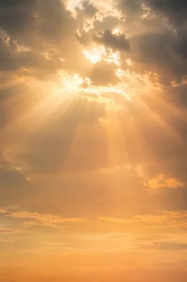 Golden Heavenly Light Rays Through Clouds
