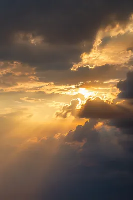 Golden Heavenly Light Rays Through Clouds
