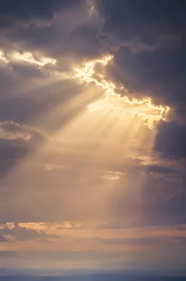 Golden Heavenly Light Rays Through Clouds