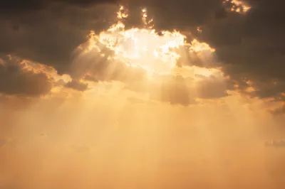 Golden Heavenly Light Rays Through Clouds