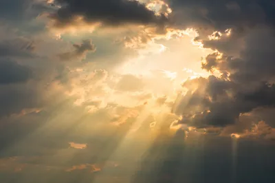 Golden Heavenly Light Rays Through Clouds