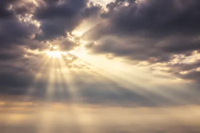 Golden Heavenly Light Rays Through Clouds
