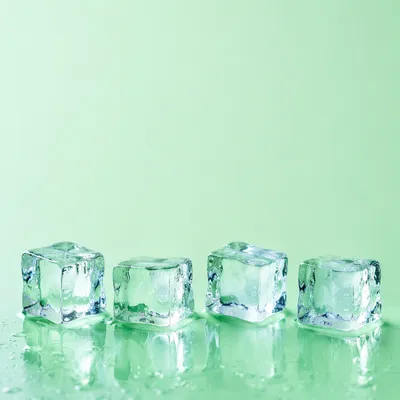 Melting Ice Cubes on Fresh Green Background