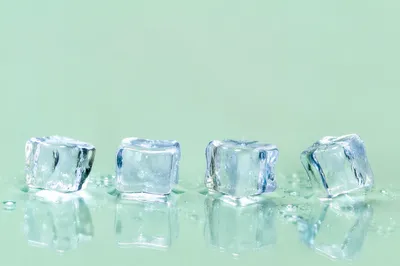 Melting Ice Cubes on Fresh Green Background