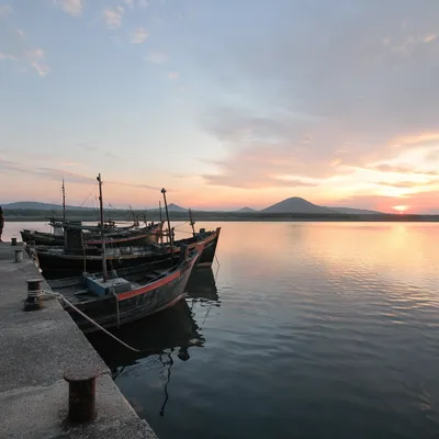 Calming Dawn Boats on Light Blue Waterfront