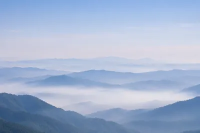 Soft Blue Misty Mountain Background