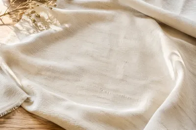 Neutral Cream Linen Fabric on Wooden Table